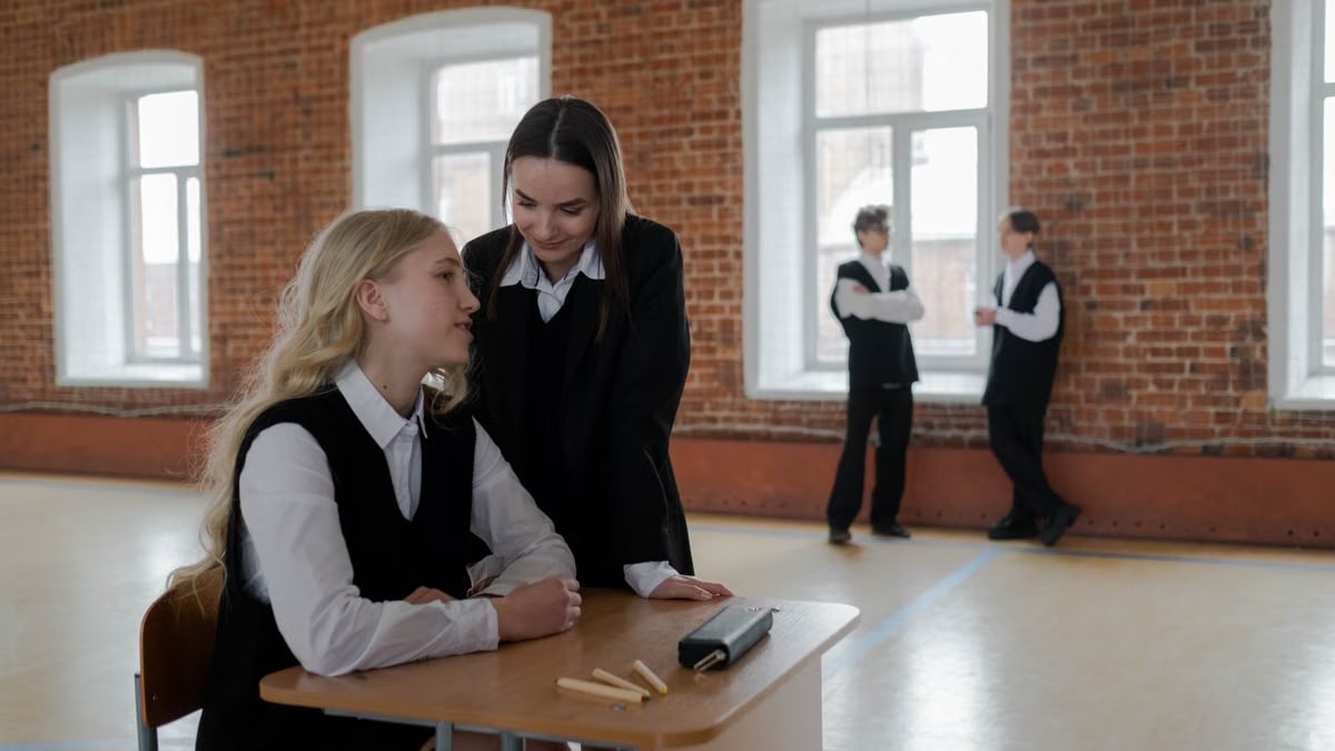 Students in a classroom setting discussing topics, highlighting the educational environment.